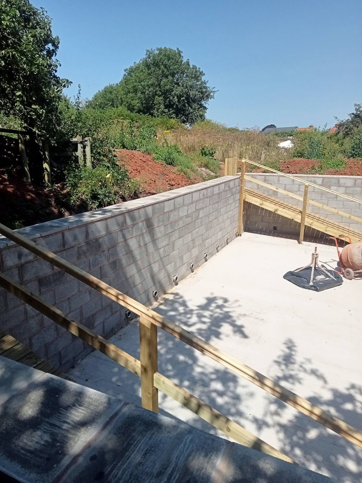 Groundworks and retaining wall foundations being built