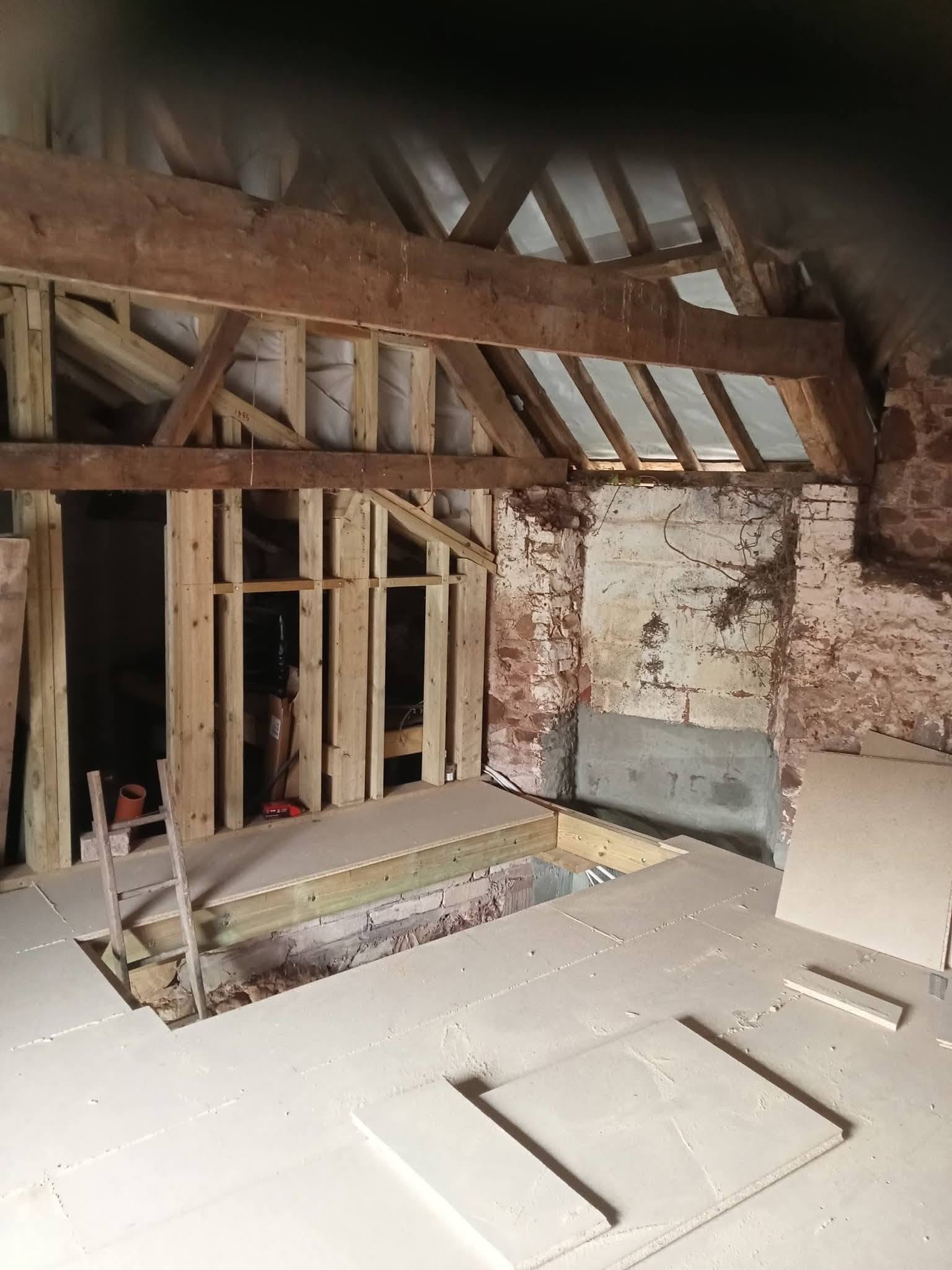 Loft conversion before: open roof timbers and unfinished stud walls