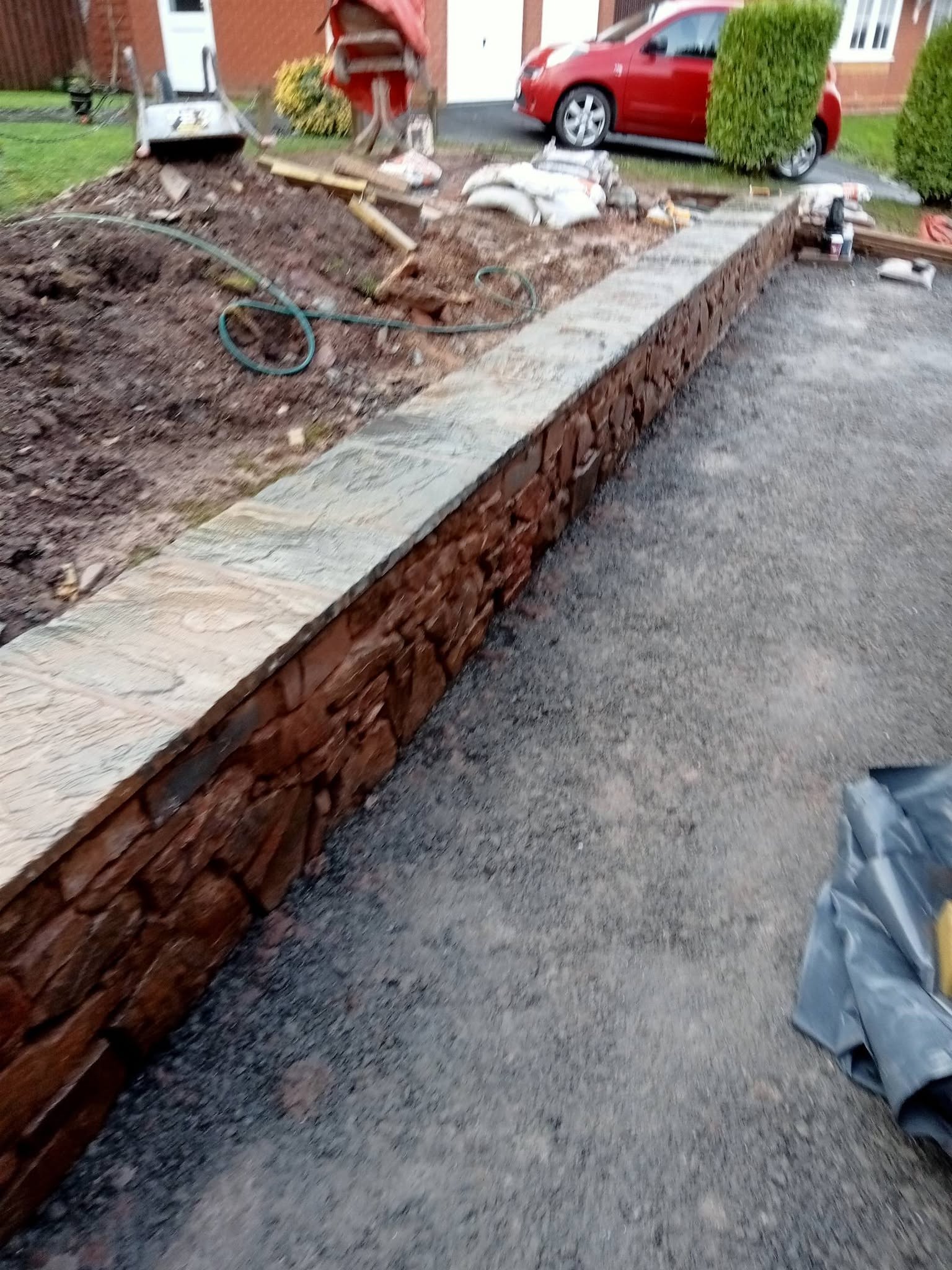 Stone retaining wall and garden landscaping in progress