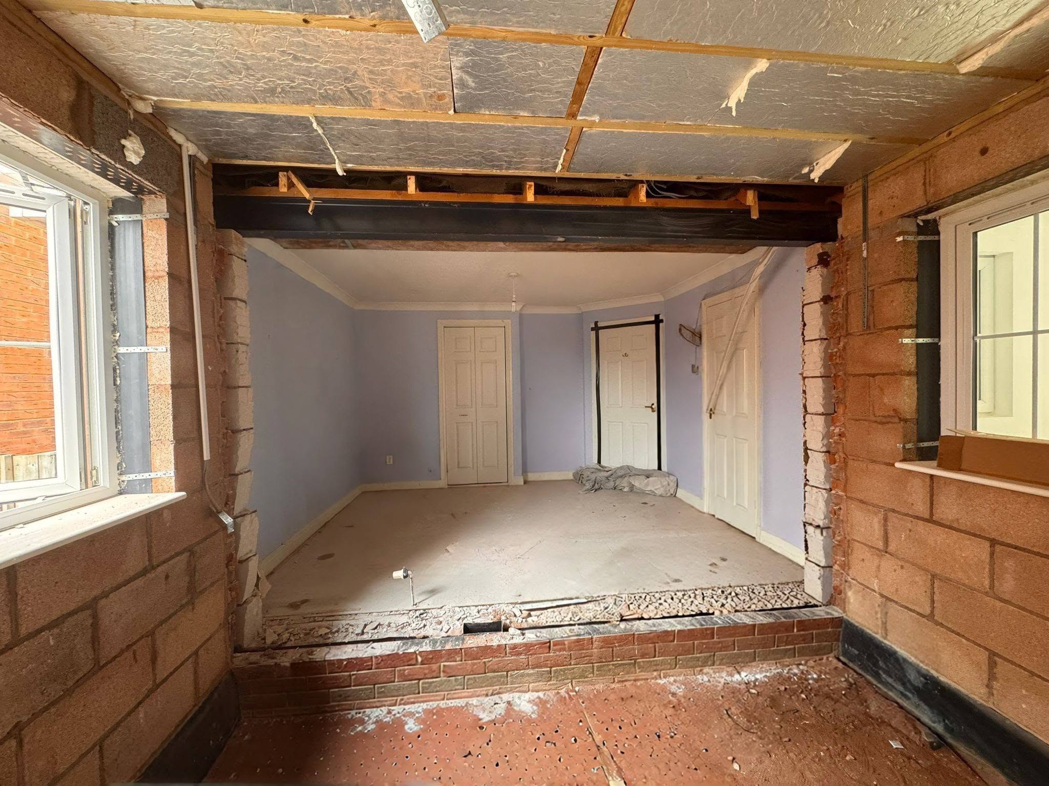Extension shell mid-build with insulation and structural beam