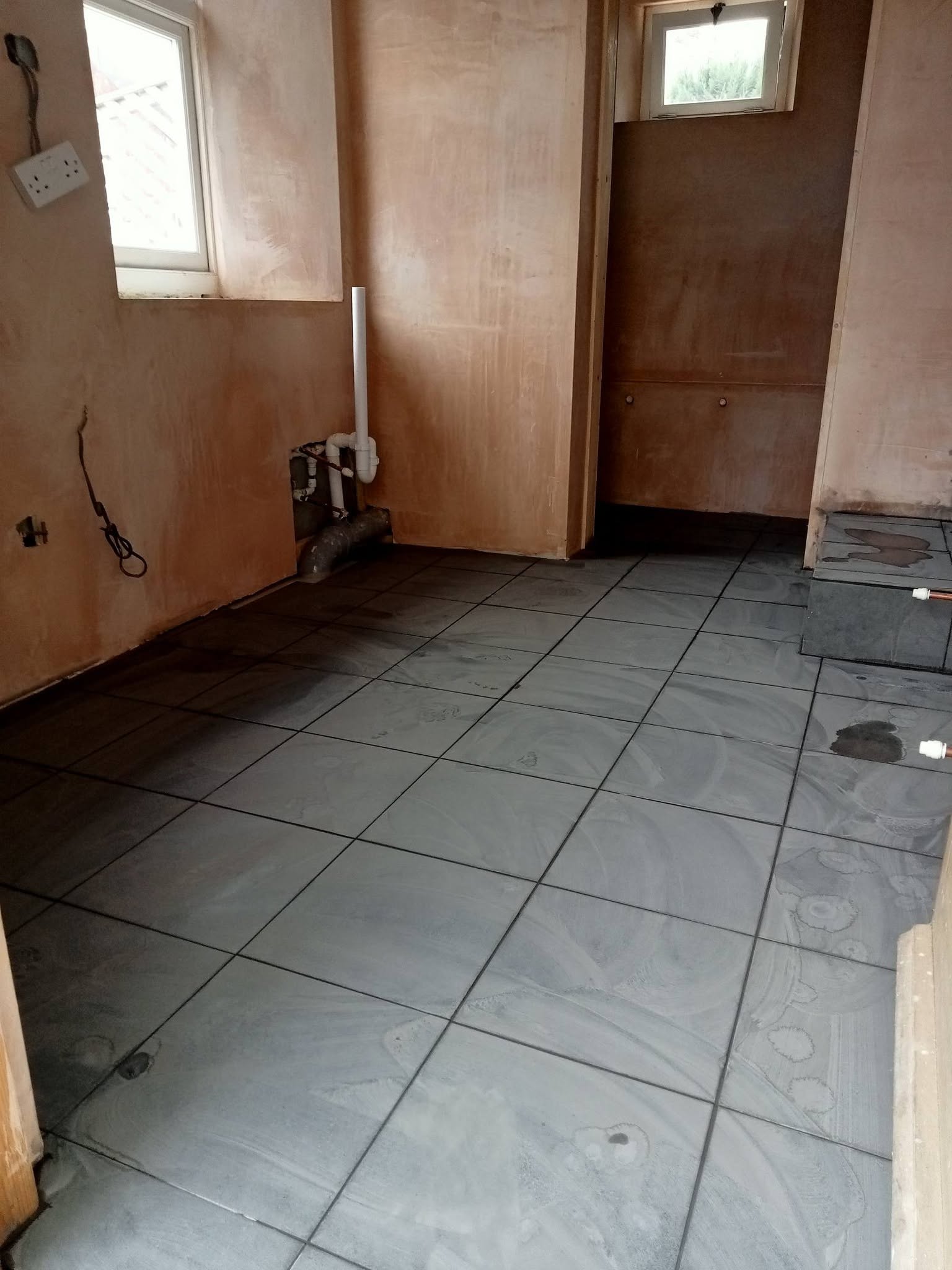 Floor tiling laid in a plastered extension room
